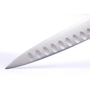Close-up of the pointed tip of the Messermeister Blacksmith Kullens Carving Knife - 9", showing oval indentations along its German stainless steel blade against a plain white background.