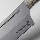 Close-up of the Messermeister Carbon Bunka Chef's Knife - 8" blade with a light-striped handle. The blade displays the Messermeister logo and "CARBON" near the spine, highlighting this full-carbon steel chef’s knife.