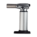 The Messermeister Cheflamme Culinary Torch by Messermeister is a silver handheld kitchen torch with a textured grip and black base, shown against a plain white background.