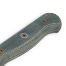 Close-up of the Messermeister Custom Blue Chef's Knife - 8" handle shows a blue-gray finish, wood grain, and three metal screws. Its curved ergonomic shape offers comfort, making this all-purpose blade ideal for any kitchen task.