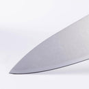 Close-up of the sharp, pointed tip of the Messermeister Custom Blue Chef's Knife - 8" featuring an ergonomic design and stainless steel blade, set against a plain white background.