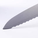 Close-up of the tip and scalloped edge of the Messermeister Custom Blue Scalloped Offset Knife - 8", featuring an offset handle, set against a plain white background.