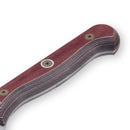 Close-up of the Messermeister Custom Red Kullens Santoku Knife - 7", showing its ergonomic layered wood handle with a reddish-brown finish and metal rivets. The partially visible blade reflects Messermeister’s expert craftsmanship.