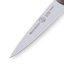 A close-up of the Messermeister Custom Red Paring Knife - 3.5" blade shows the Messermeister brand name, logo, and Solingen Germany 8681-3.5B engraved on the metal, with a sharp pointed tip for precision tasks.