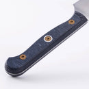 Close-up of the Messermeister Custom Utility Knife - 6" handle, featuring a textured dark blue grip and three metallic rivets, set against a plain white background.