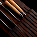 The Messermeister In-Drawer Knife Holder - 11 Slot by Messermeister neatly organizes knives with blades and handles displayed in their dedicated slots, offering elegant and space-saving knife storage in your kitchen drawer.