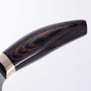 Close-up of the dark wooden handle on the Messermeister Kawashima Nakiri Knife - 6.5", highlighting its smooth grain and metal band near the blade, from Messermeister, set against a plain white background.