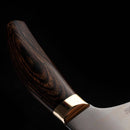 Close-up of the Messermeister Kawashima Slicer - 10" handle, crafted from dark polished wood with visible grain and a shiny metal bolster, highlighting Messermeister's Japanese-inspired design against a black background.