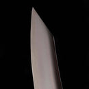 Close-up of the sharp blade of the Messermeister Kawashima Slicer - 10" against a black background, showcasing its smooth, reflective SG2 Powdered steel and pointed tip—a testament to Messermeister’s Japanese craftsmanship.