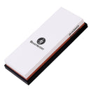 The Messermeister Maintenance Stone – 1000 & 3000 Grit – is a rectangular dual-sided water stone on a black base, ideal for precise knife sharpening and honing.