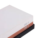 The Messermeister Maintenance Stone features 1000 grit on the brown side and 3000 grit on the white side, and sits securely on a black base for precise knife sharpening.