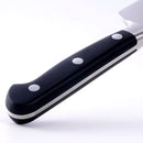 Close-up of the Messermeister Meridian Elite Chef's Knife - 6" with an ergonomic black handle with three silver rivets, showing part of the high-carbon German steel blade and tang against a white background.
