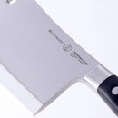 Close-up of a Messermeister Meridian Elite Heavy Cleaver - 6", highlighting the Messermeister logo and text on the German stainless steel blade, with a portion of the black handle shown against a white background.
