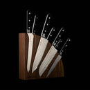 The Messermeister Meridian Elite Magnet Block Set - 8 Piece features German steel knives with black three-rivet handles displayed in a dark wood magnetic block, set against a black background.