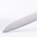 A close-up of the scalloped blade on the Messermeister Meridian Elite Offset Bread Knife - 8", crafted from German steel, set against a plain white background.