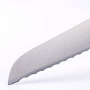 Close-up of the Messermeister Meridian Elite Scalloped Bread Knife - 9" tip and serrated edge, highlighting its blade against a white background.