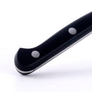 Close-up of the black handle of the Messermeister Meridian Elite Scalloped Utility Knife - 5", featuring two metal rivets and a curved end, precision-forged in Germany from high-carbon stainless steel, shown on a white background.