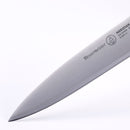 Close-up of the razor-sharp precision tip of a Messermeister Meridian Elite Spear Point Paring Knife - 4", crafted in Germany, shown against a white background with the Messermeister brand name and logo engraved on the blade.