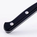 Close-up of the black handle with two metal rivets from the Messermeister Meridian Elite Starter Set - 3 Piece, displayed against a plain white background.