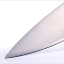 Close-up of the sharp blade on the Messermeister Meridian Elite Stealth Chef's Knife - 9", featuring high-carbon stainless steel, shown against a white background.