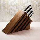 Four black-handled knives are neatly arranged in the Messermeister Next Level Magnetic Knife Block - UV Light by Messermeister, sitting on a white countertop with a hexagonal tile backsplash in the background.