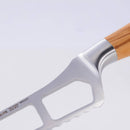 The Messermeister Oliva Elite Cheese & Tomato Knife - 5" features a German stainless steel blade with rectangular cutouts and a serrated edge, plus an olive wood handle—ideal for slicing soft cheeses and tomatoes without sticking.