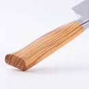 Close-up of the Messermeister Oliva Elite Chef's Knife (10"), showing its light olive wood handle with visible grain and a German stainless steel blade against a plain white background.