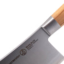 Close-up of the Messermeister Oliva Elite Heavy Cleaver - 6", featuring an olive wood handle and a blade engraved OLIVA ELITE SOLINGEN-GERMANY with a logo and model number E/6651-6. Made from high-carbon stainless steel for lasting sharpness.
