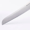 Close-up of the Messermeister Oliva Elite Reverse Scalloped Utility Knife - 6", featuring a rounded tip and German stainless steel blade, displayed on a plain white background.