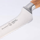 Close-up of the Messermeister Oliva Elite Offset Scalloped Bread Knife - 8" with a wooden handle, crafted from German stainless steel and etched with the Messermeister brand, model name, and "Made in Solingen, Germany.