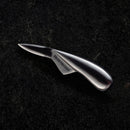 The Messermeister Oyster Knife - 6.5" features an ergonomic handle and Messermeister logo on its stainless steel blade, resting elegantly on a dark, textured surface.