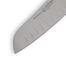 Close-up of the Messermeister Petite Messer Orange Kullens Santoku Knife - 5", showing the brand logo, product name, and kullens (hollow edge) on its high-carbon stainless steel blade.