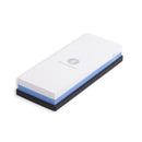 The Messermeister Polishing Stone - 2000 & 5000 Grit is a dual-sided rectangular water stone with a white top, blue bottom, and black base, perfect for sharpening and maintaining knives and tools.