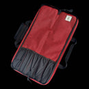 The Messermeister Preservation Heather Red Knife Roll—5 Pocket is made from recycled water bottles, features multiple pockets, a zipper, handle, and patch label. Displayed open and empty against a black background, it’s perfect for kitchen storage.