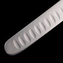 Close-up of the Messermeister Pro Series Round-Tip Kullens Slicer - 12" blade, showing its oval indentations. Crafted from German stainless steel by Messermeister, set against a black background.