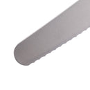 Close-up of the Messermeister Pro Series Scalloped Baker's Knife - 10" showing its textured, serrated edge and rounded tip against a white background.