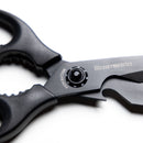 Close-up of Messermeister Push Button Take-Apart Multi Shears - 9", featuring high-carbon stainless steel blades, a visible push button near the pivot, and black handles against a white background.