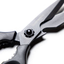 Close-up of Messermeister Push Button Take-Apart Multi Shears - 9", featuring black high-carbon stainless steel, a visible screw mechanism, and textured handles, set against a white background.