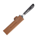 A black and silver-handled knife is partially inserted into the Messermeister Saddle Brown Leather Magnetic Edge-Guard - 6.5" on a white background.