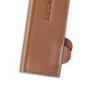 Close-up of a Messermeister Saddle Brown Leather Magnetic Edge-Guard (8.5") with visible stitching and embossed logo, partially open to show a small circular tab, set against a white background.