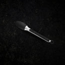 The Messermeister Silicone Coated Locking Tongs - 9" feature a black and silver finish with a textured handle, resting on a dark surface—an ideal addition to your collection of nonstick-safe kitchen tools.