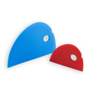 The Messermeister 2 Piece Silicone Bowl Scraper Set includes a large blue and a smaller red scraper, each with rounded edges and a circular hole at the top right—essential kitchen tools resting on a white background.
