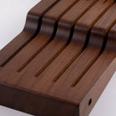 A close-up of a Messermeister In-Drawer Knife Holder - 11 Slot, featuring curved slots to securely hold knives, displayed against a plain white background.