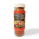A clear jar of SALTOPIA Infused Sea Salts labeled "Saltopia Taco Seasoning: HOLY MOLY" features a taco photo on the front. The reddish-orange blend inside delivers authentic flavor, perfect as taco seasoning. Displayed against a white background.