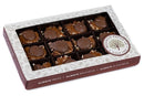 Presenting the Millican Pecan Milk Chocolate Caramillicans Gift Box – a delightful offering from Millican Pecan, featuring twelve handcrafted pieces of pecan candy layered with smooth caramel and topped with rich milk chocolate. The elegant gift box is adorned with the Millican Pecan logo, making it an ideal treat for any occasion.
