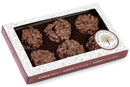 A Millican Pecan Milk Chocolate Pecan Clusters Gift Box contains five gourmet clusters, elegantly presented in a white and maroon box featuring a clear window and the Millican Pecan logo, with the message “Always Fresh, Always Delicious, Always Flavorful.”.