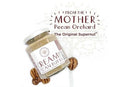 A jar of Millican Pecan Creamy Pecan Butter - 8.5 oz Natural Texas Pecan Spread lies beside whole Texas pecans. Above, the text reads FROM THE MOTHER Pecan Orchard The Original Supernut.
