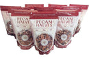 Eight standing bags of Millican Pecan Orchard Fresh Raw Pecan Halves - Premium Shelled Texas Pecans in red and white packaging with a window showing grade 1 pecans and front nutritional info. Brand: Millican Pecan.