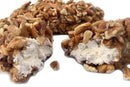 Close-up of Millican Pecan Old-Fashioned Pecan Log Rolls - 5 oz by Millican Pecan, featuring crunchy Texas pecans surrounding a soft white nougat center and delicious caramel layer, set against a white background—an irresistible taste of classic Southern candy.