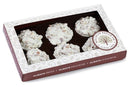 A Millican Pecan White Chocolate Pecan Clusters Gift Box by Millican Pecan, featuring five pecan clusters in elegant white and brown packaging with a clear window and the company logo displayed in the top right corner—perfect as a gourmet pecan candy gift.